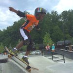 Photo of child skateboarding with text: Sign up for Summer!