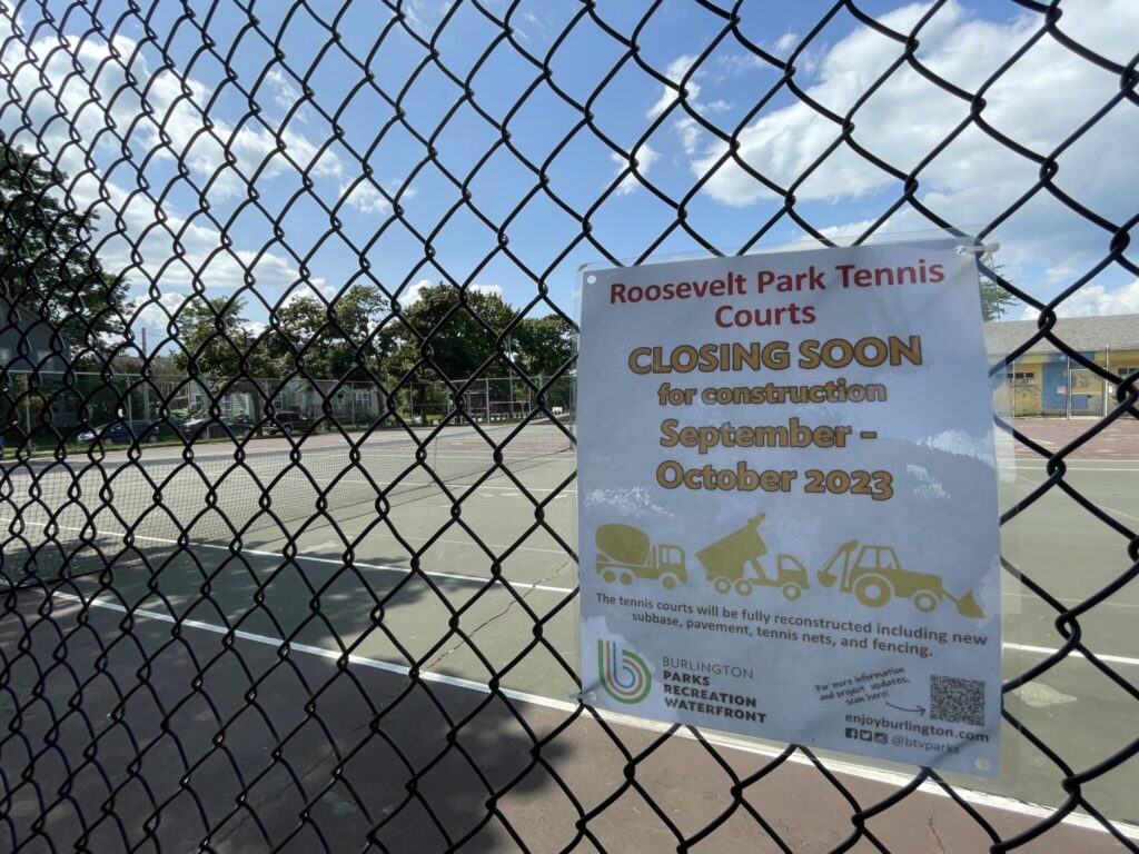 Image of chain link fence with aging tennis courts in background. Sign on fence reads: Roosevelt Park Tennis Courts closing soon for reconstruction, September to October 2023.